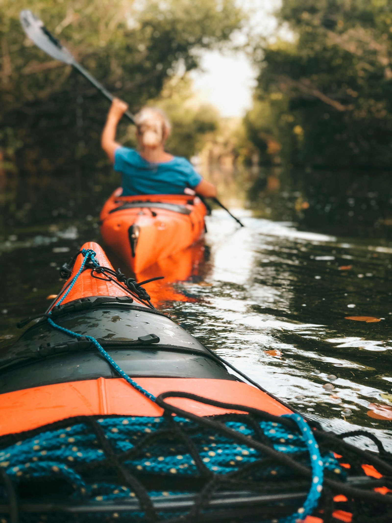 paddler holding an oar on a kayak - Rivara Kayak - paddle sports gear for dealers